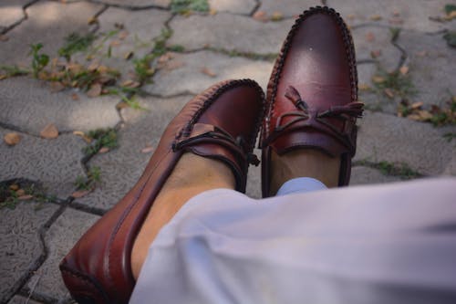 A Person Wearing a Leather Shoes