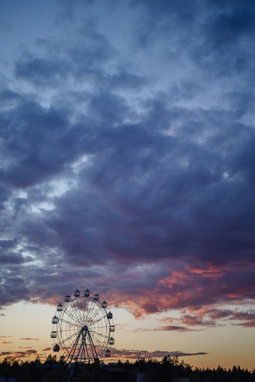 Ferris Wheel under Cloudy Evening Sky
