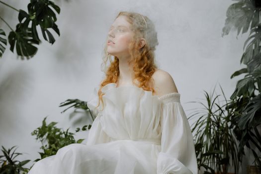 Woman Sitting Beside Green Plants