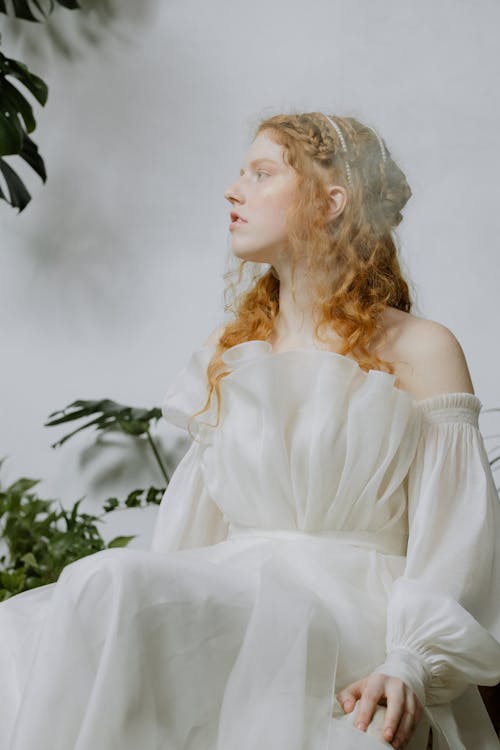 A Woman Wearing an Off Shoulder White Dress