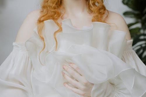 Close-Up Shot of a Redhead Woman Wearing White Dress