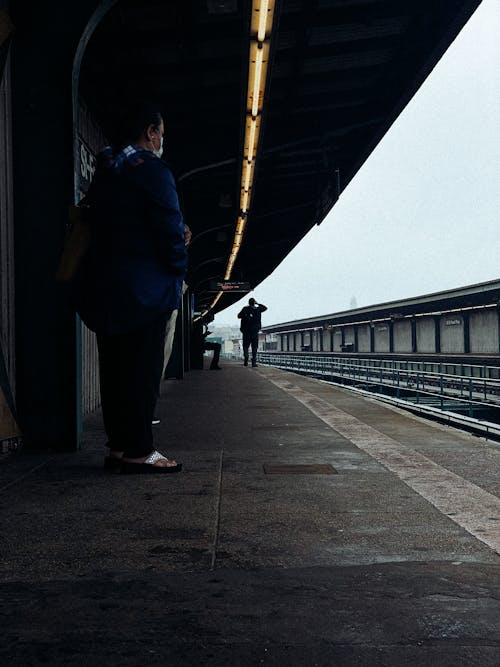 People standing on platform while waiting for train