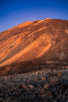 Beautiful view of a sunlit mountain in Santa Cruz de Tenerife with a clear blue sky.