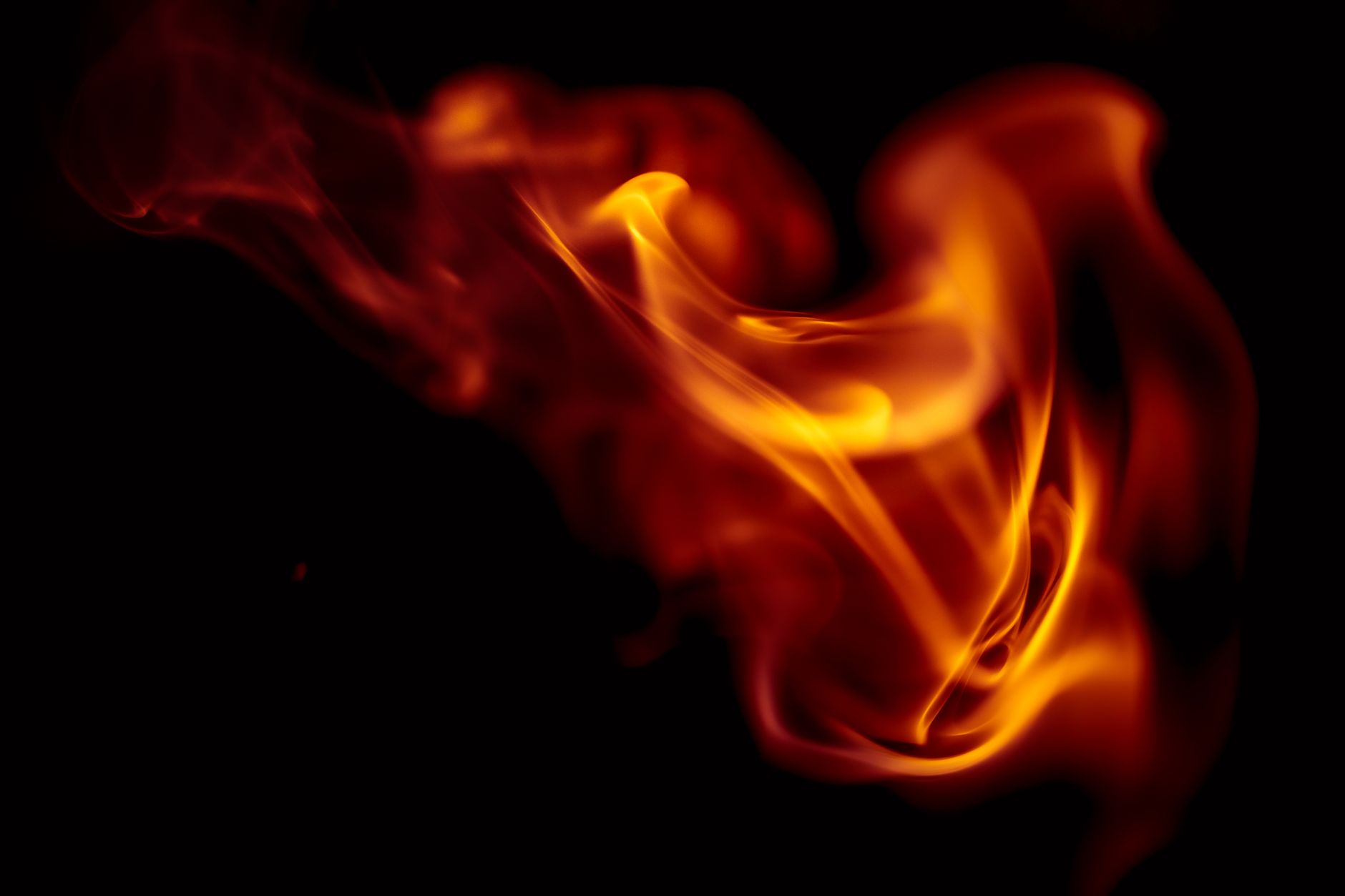 Close-up of vibrant flames in motion on a dark background, conveying heat and energy.