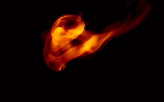 A striking image of a dynamic fire flame against a black background, showcasing fiery motion.