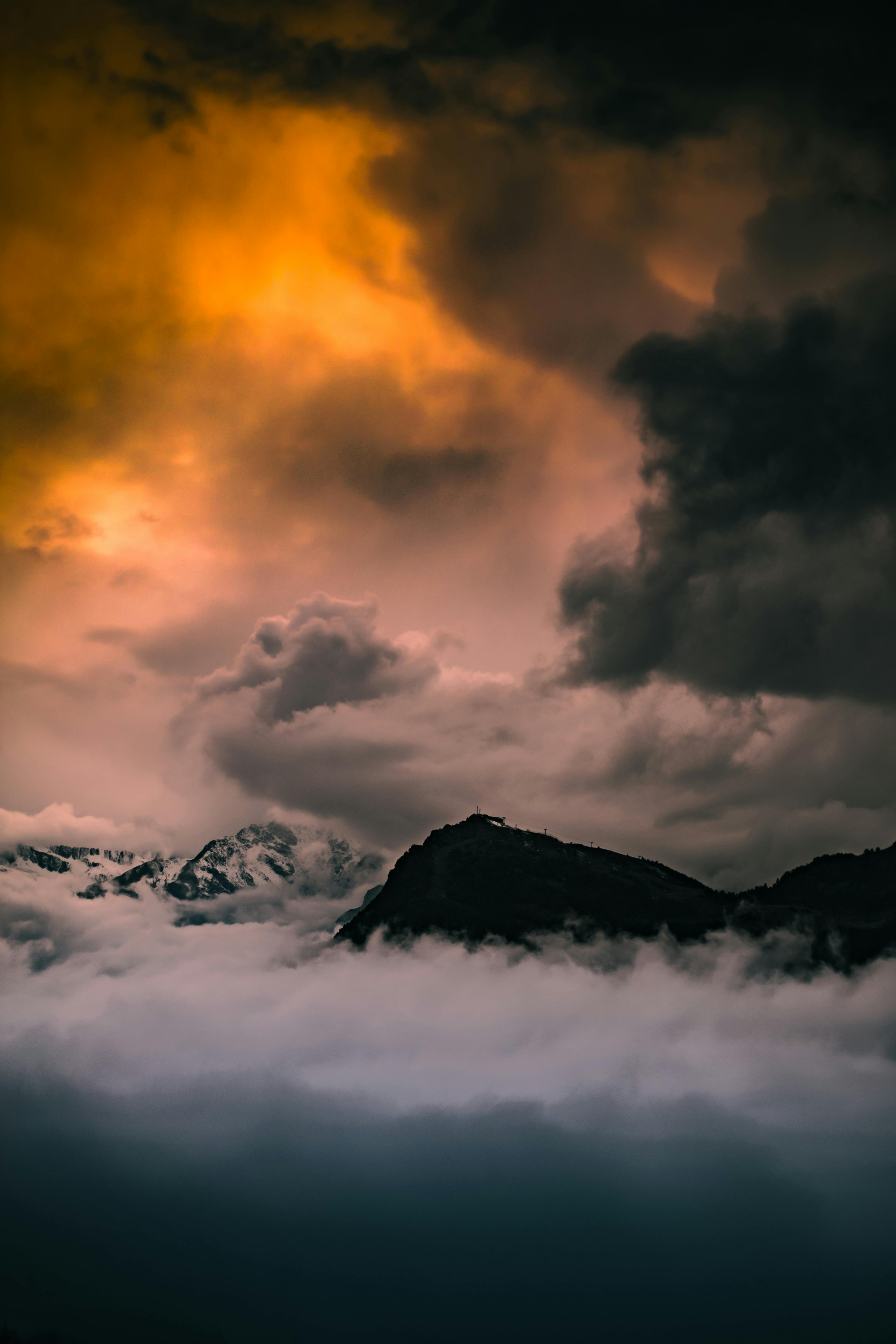 Prescription Goggle Inserts - Epic scene of cloudy sunset over misty mountains in Italy, creating a dramatic atmosphere.