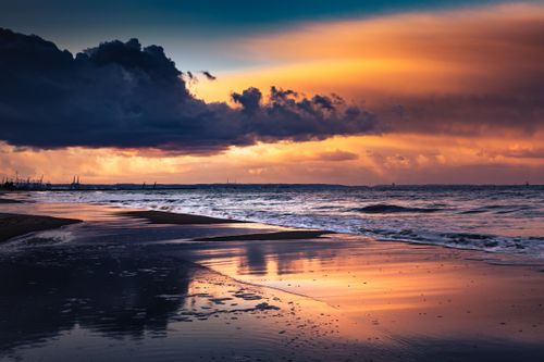 Free Captivating sunset over the Baltic Sea coast in Gdańsk, Poland, showcasing rich colors and a peaceful beach. Stock Photo