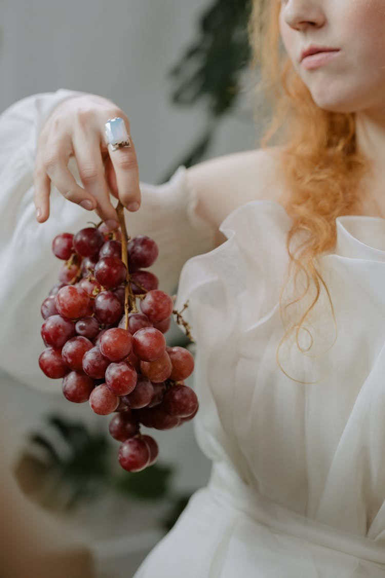 Woman In White Dress Holding Grape Fruit