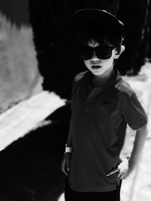 Grayscale Photography of Boy Wearing Polo Shirt and Sunglasses