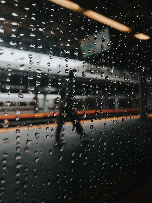 View from window of train of anonymous person walking