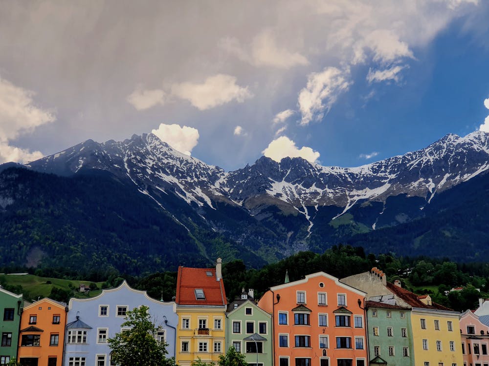 A Colorful Buildings Near the Mountain Under the Blue Sky and White Clouds