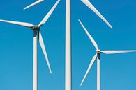 White Wind Turbine Under Blue Sky