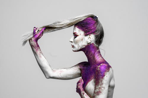 Topless Woman With Purple Glitters on Her Body 