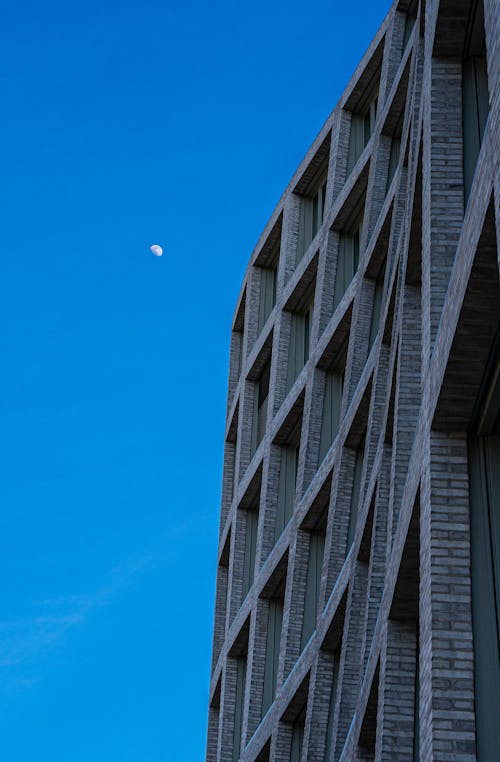 Gray Concrete Building Under the Clear Blue Sky