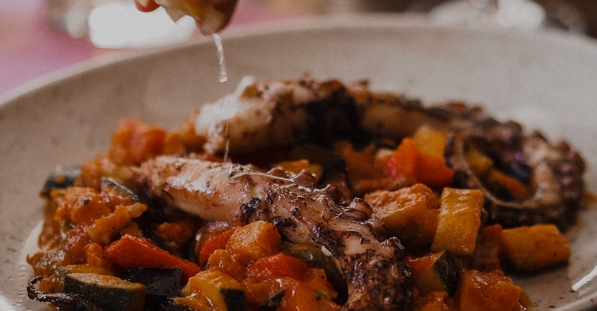 Person Squeezing Lemon on his Food
