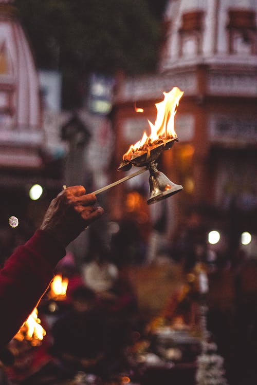 Person Holding Lamp With Flame