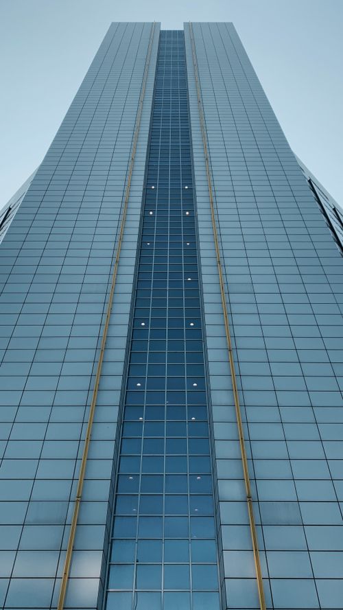 Free Low angle view of a modern glass skyscraper in Amsterdam, Netherlands. Stock Photo