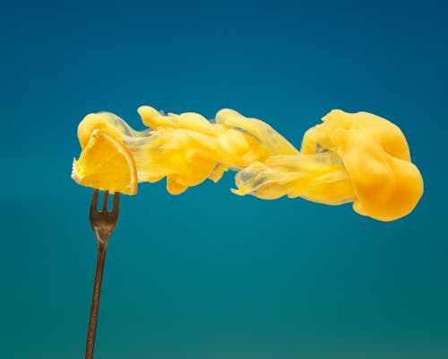 Close Up of Orange Smoke and Fruit on Fork