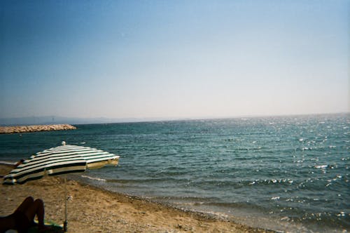 Person on the Beach Lying on the Sand 