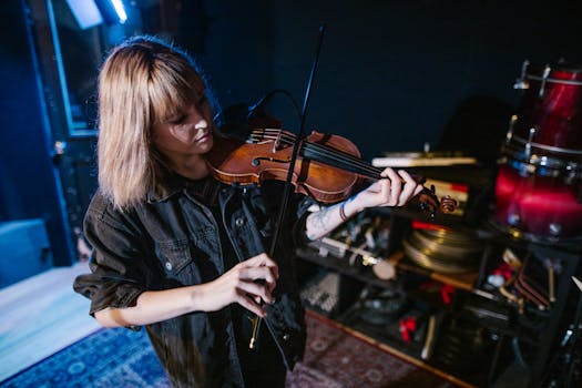 A woman violinist playing in a studio environment, showcasing musical passion and skill.