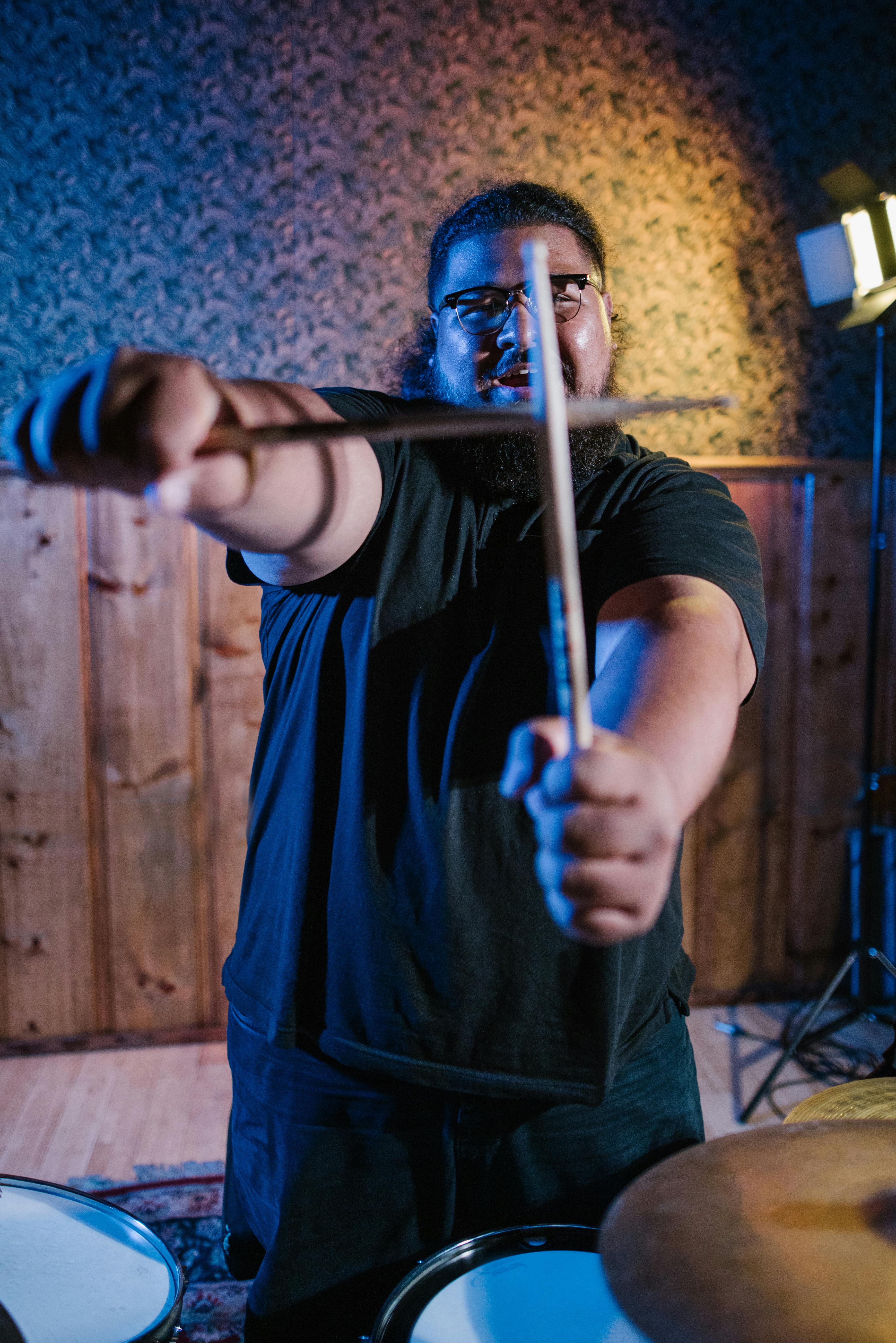 A Man Holding Drumsticks · Free Stock Photo
