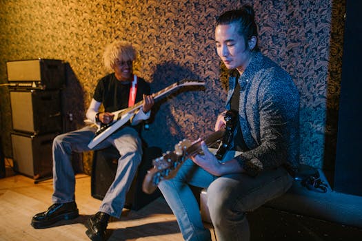Two musicians playing guitar and bass in a cozy rehearsal space, focusing on creativity and collaboration.
