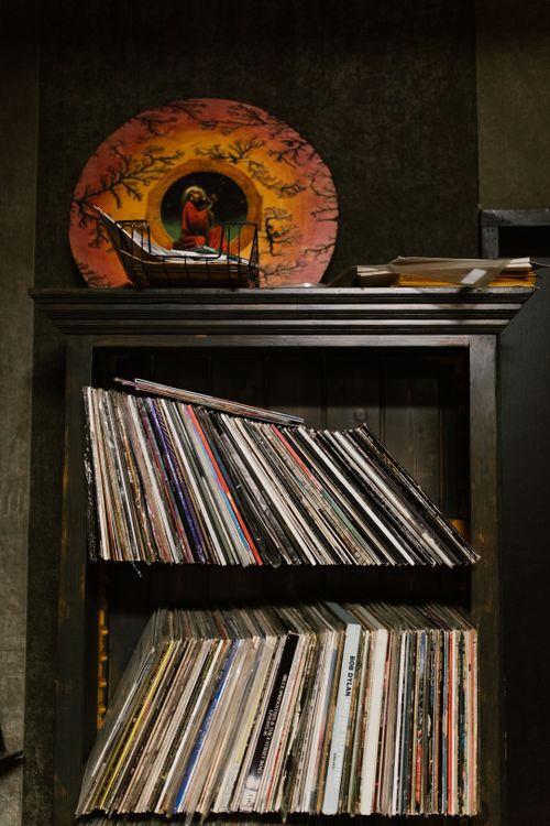Free A vintage collection of vinyl records neatly arranged on wooden shelves, perfect for music enthusiasts. Stock Photo