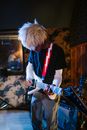Man in Black and White T-shirt Playing Electric Guitar