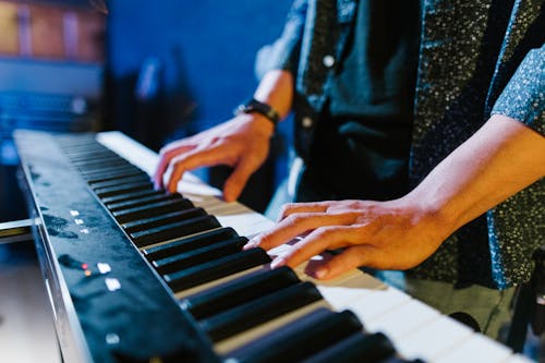 Close-Up Shot of a Person Playing Piano