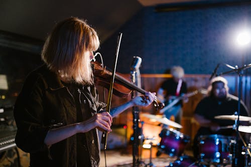 Woman Playing Violin on Stage