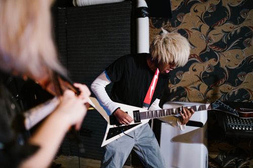 Free A person practicing electric guitar skillfully in an indoor music setting. Stock Photo