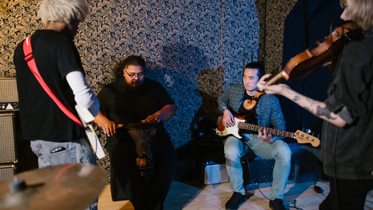 Musicians rehearsing together in a recording studio