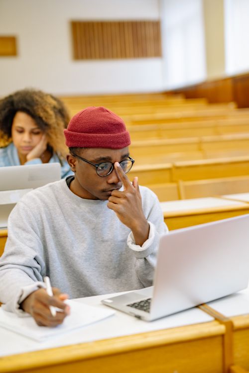 Students working on laptops in a lecture hall, photo by Yan Krukau on Pexels