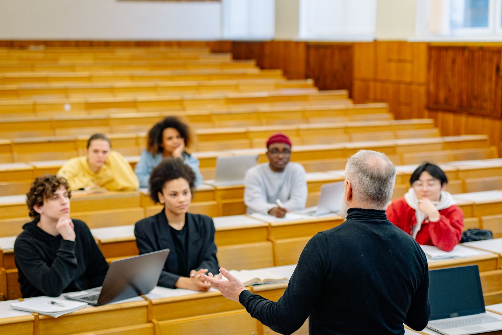 Students taking notes in a university lecture hall