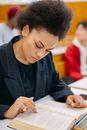 Man in Black Long Sleeve Shirt Writing on White Paper