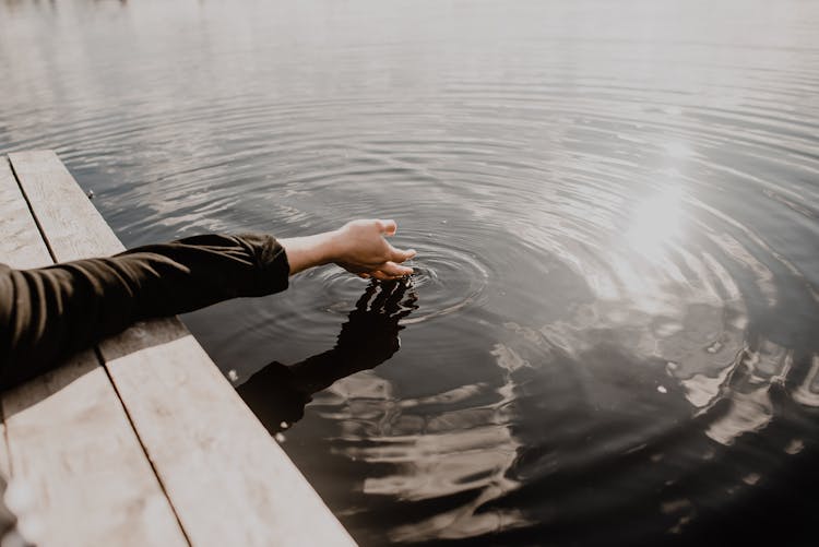 Hand Touching Water Surface