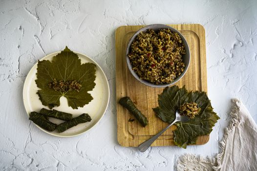 Top view of dolma yalanji with rice on grape leaves showcasing Middle Eastern cuisine.