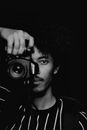 Man in Black Crew Neck Shirt Holding Black Camera