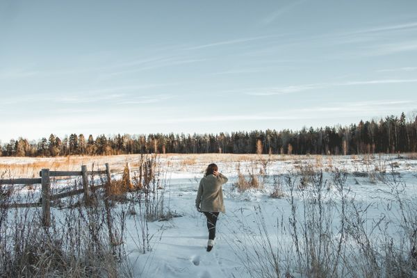 A person walking across a snowy field — photo by Oleg Karsakov on Pexels