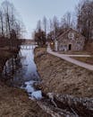 Stone House Near Body of Water and Leafless Trees
