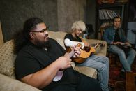 Man in Black Crew Neck T-shirt Playing Brown Acoustic Guitar