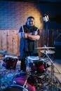 Man in Blue Shirt Playing Drum