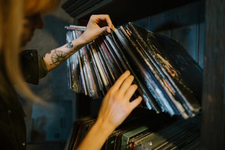 Close-up Of Woman Looking Through Records On A Shelf