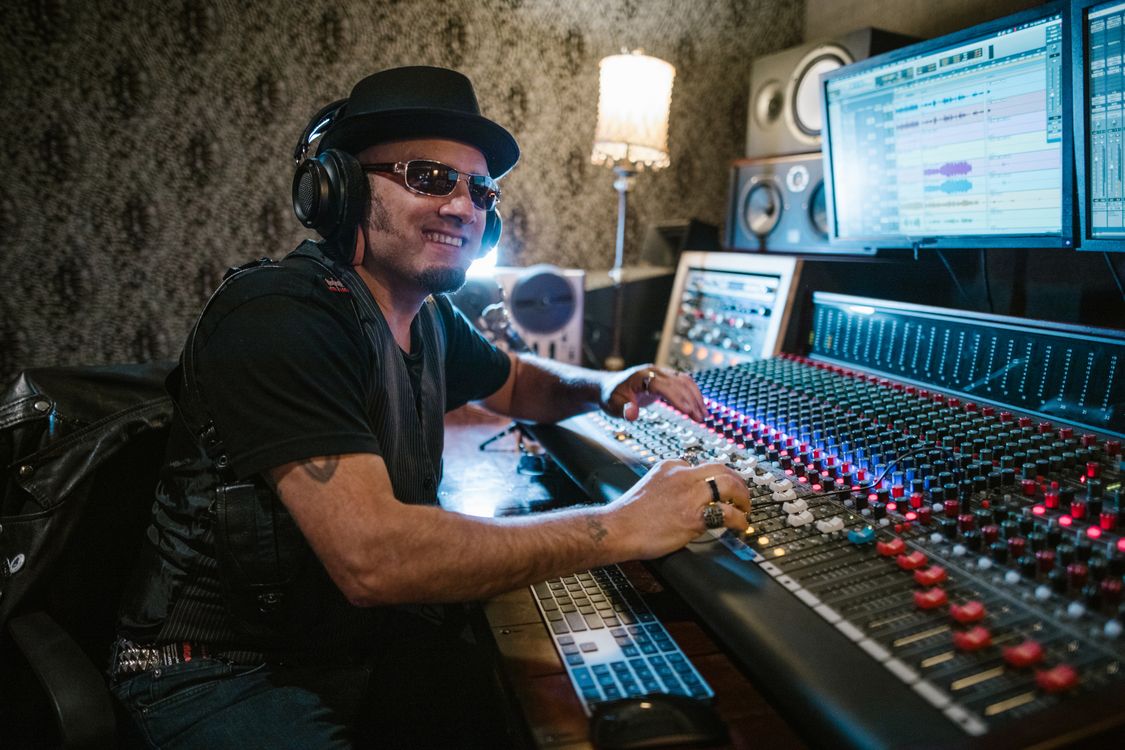 Man in Black Shirt Playing Audio Mixer