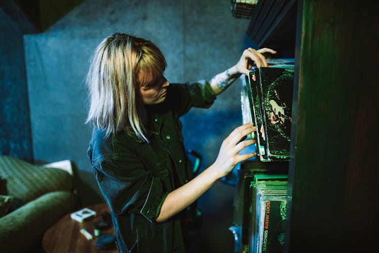 Woman Looking Through Records On A Shelf