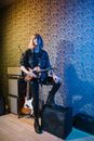 Woman in Blue Jacket and Black Pants Holding Electric Guitar