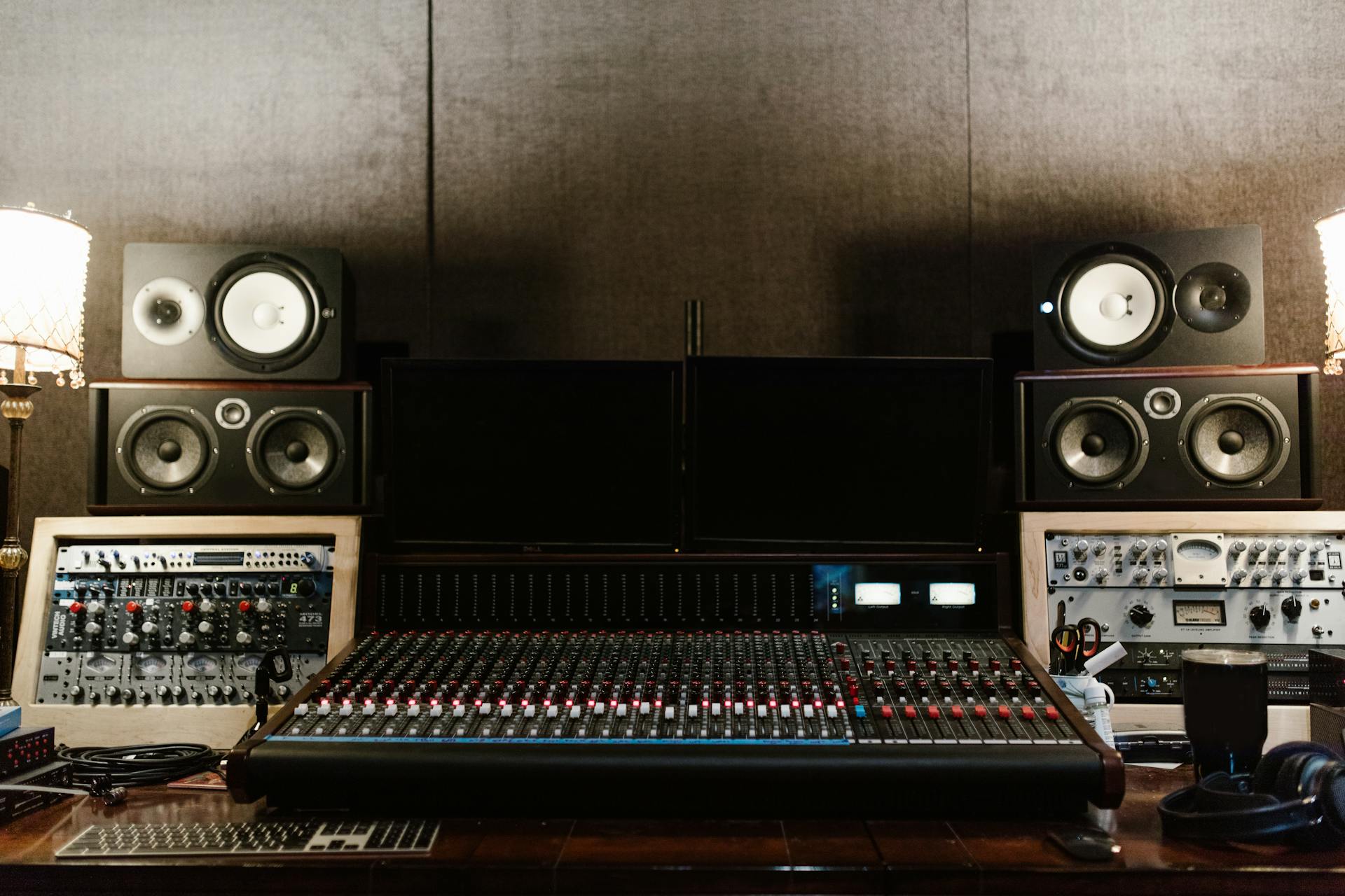 High-quality recording studio setup with sound mixer and speakers, ideal for music production.