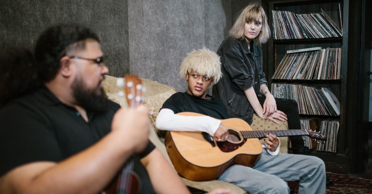 diverse group of musicians collaborating in modern recording studio