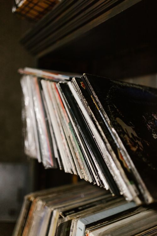 Free Close-up of a collection of vintage vinyl records neatly stacked on a shelf in a music studio. Stock Photo