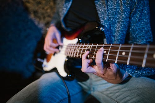 Person Playing the Guitar